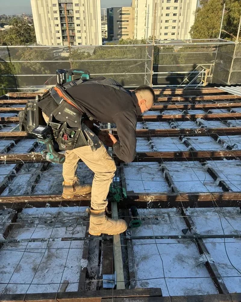 Carpenter fixing off new roof timbers
